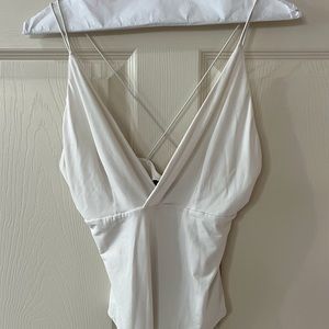 Woman’s white cross bodysuit size medium